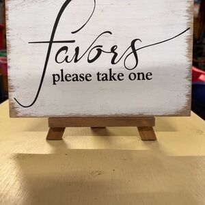 White Favor Sign on Wooden Stand